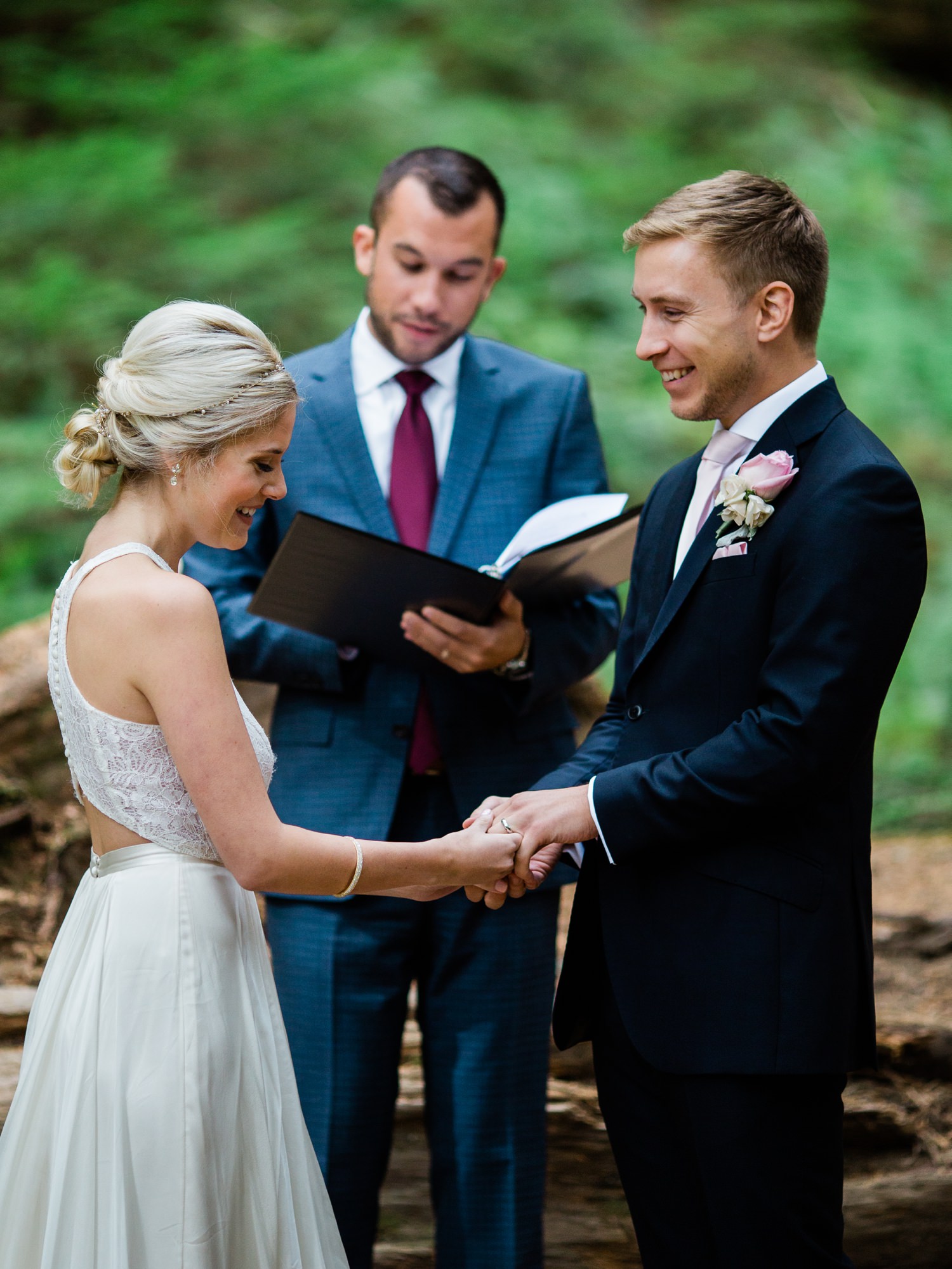 bride and groom exchange rings at national park wedding
