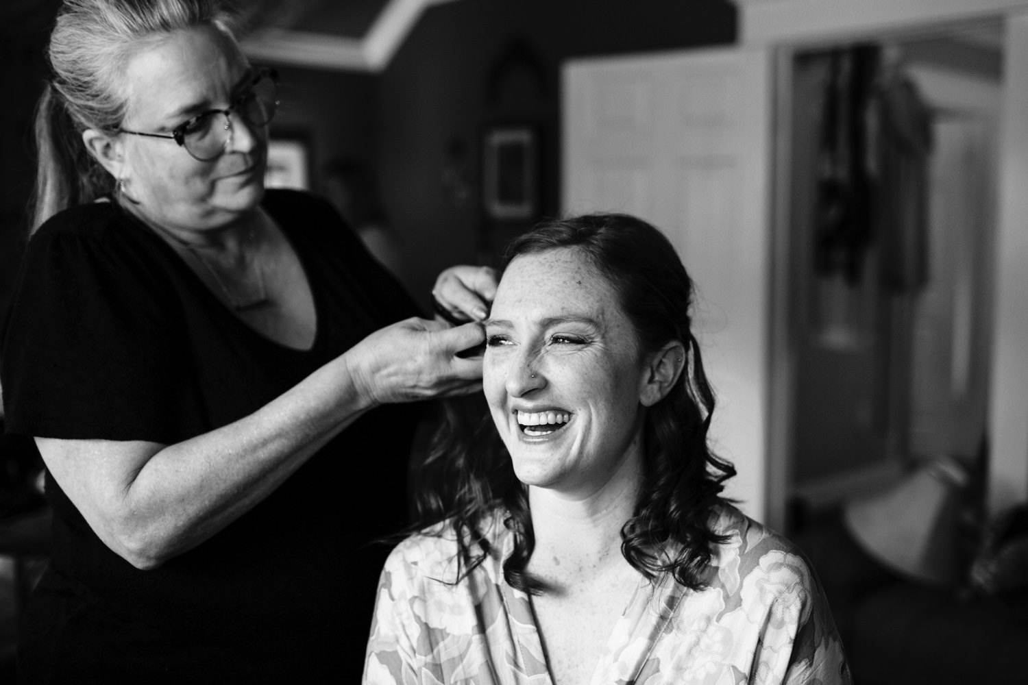 bride getting her hair done on wedding day