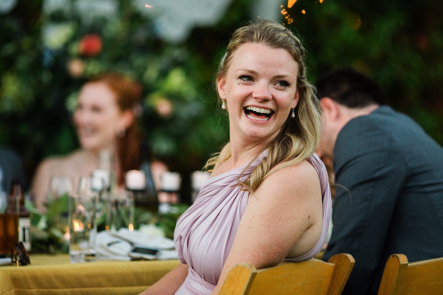 wedding guest laughing during toasts at sova gardens