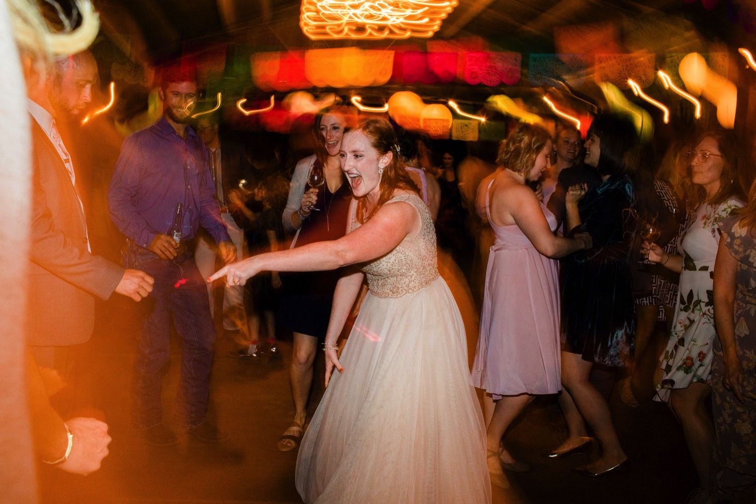 destination wedding photographer captures bride dancing at Sova Gardens