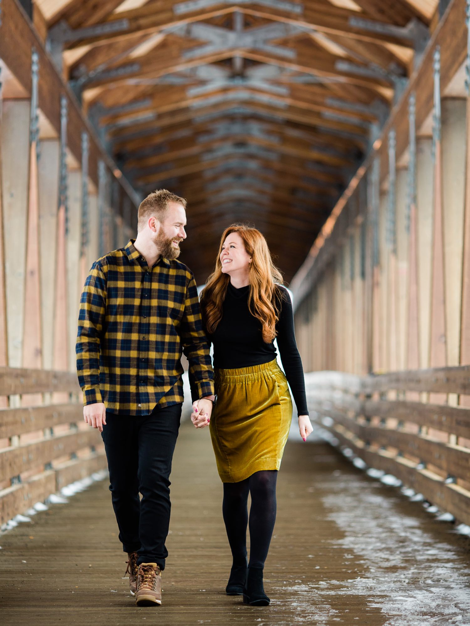 engaged couple walking across bridge at Alpental in Washington