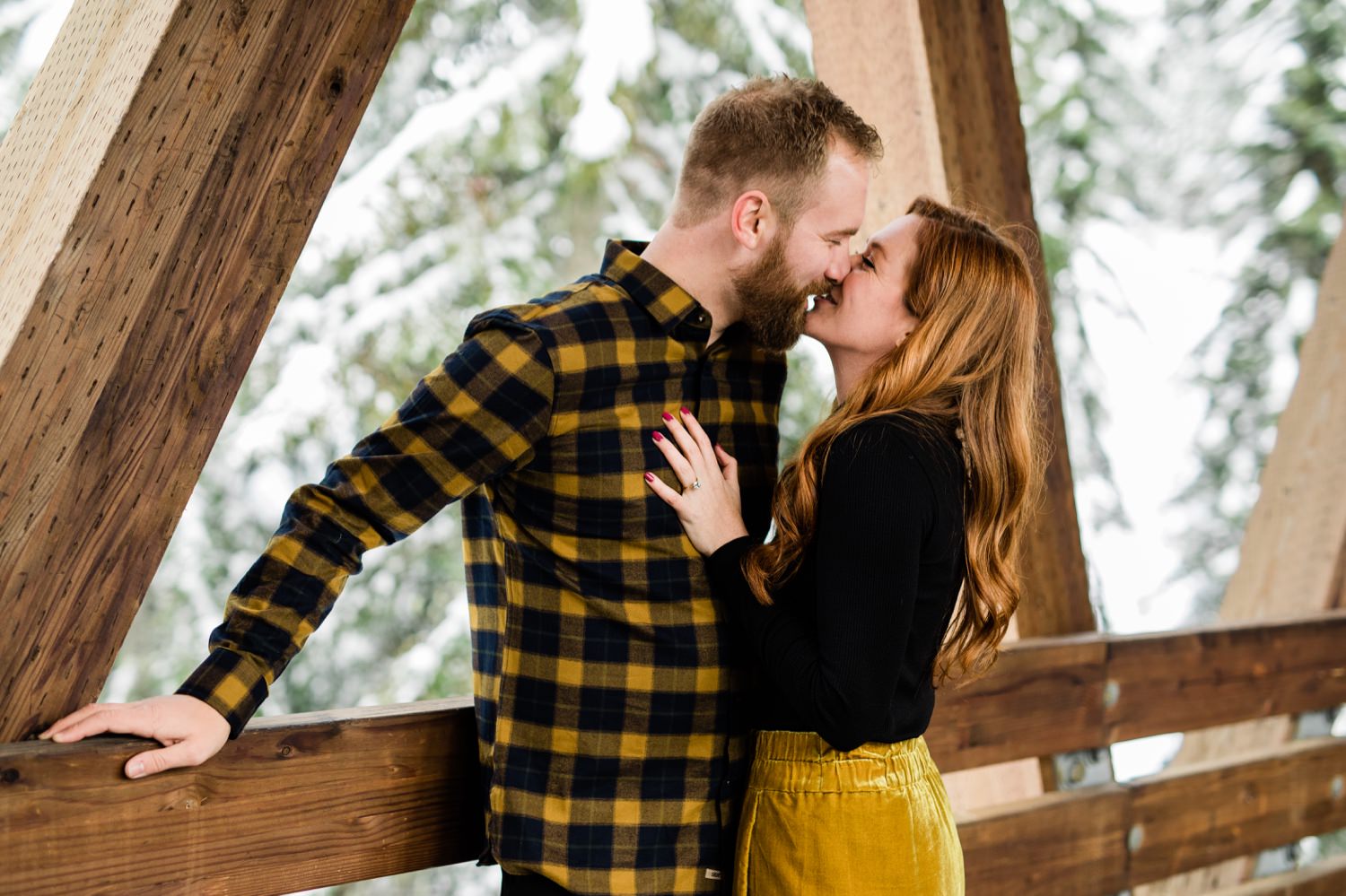 couple kissing on bridge at Alpental