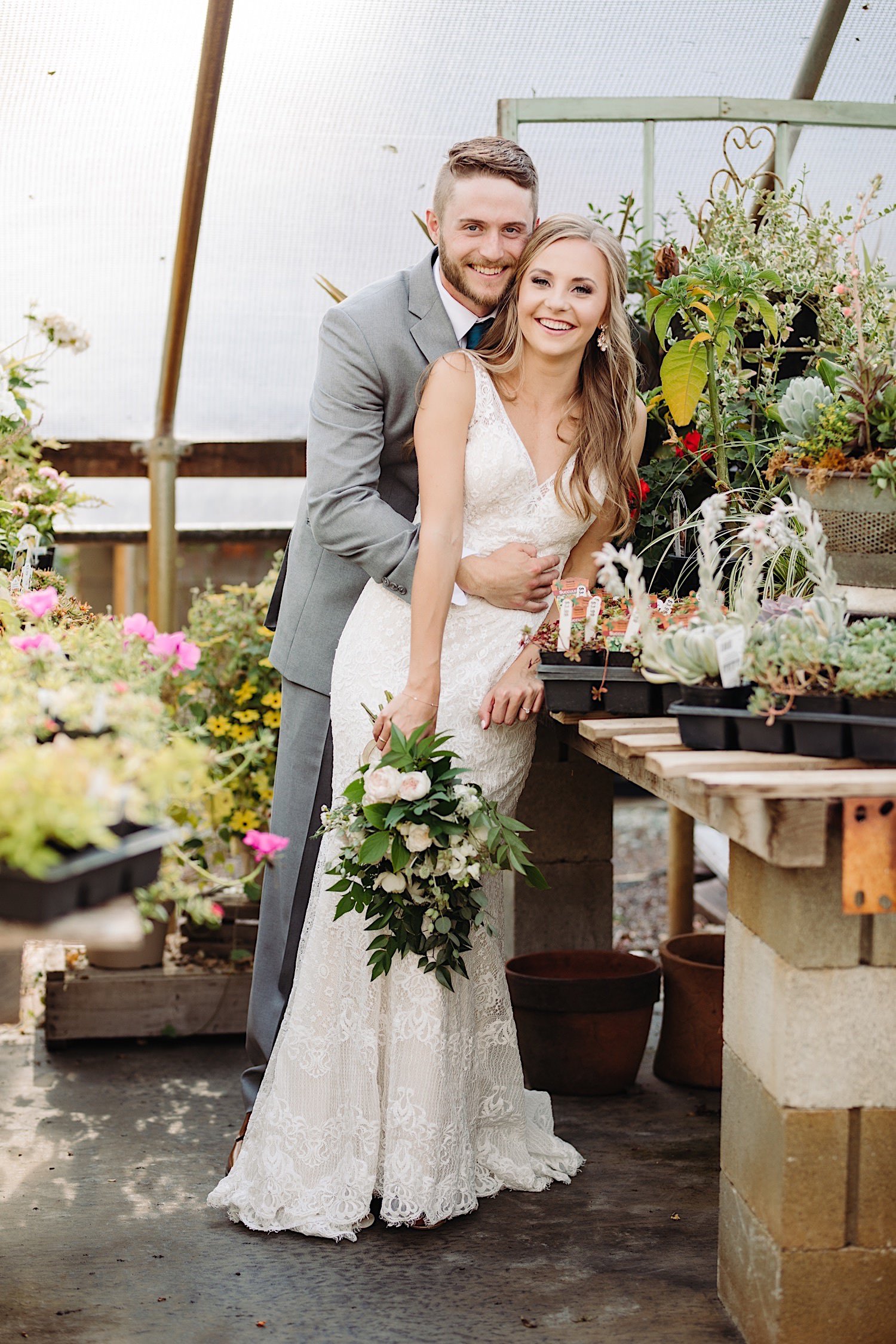 wedding couple portraits in a greenhouse at Pine Creek Farms and Nursery