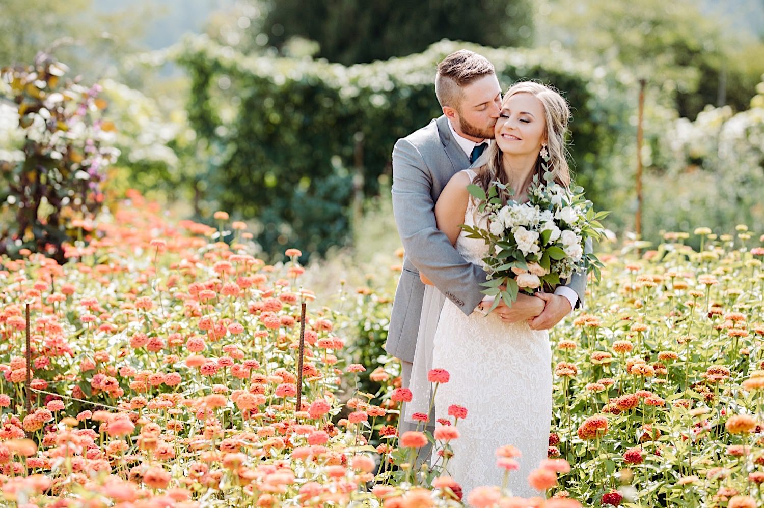 wedding day couple's portraits in a flower field at Pine Creek Farms and Nursery