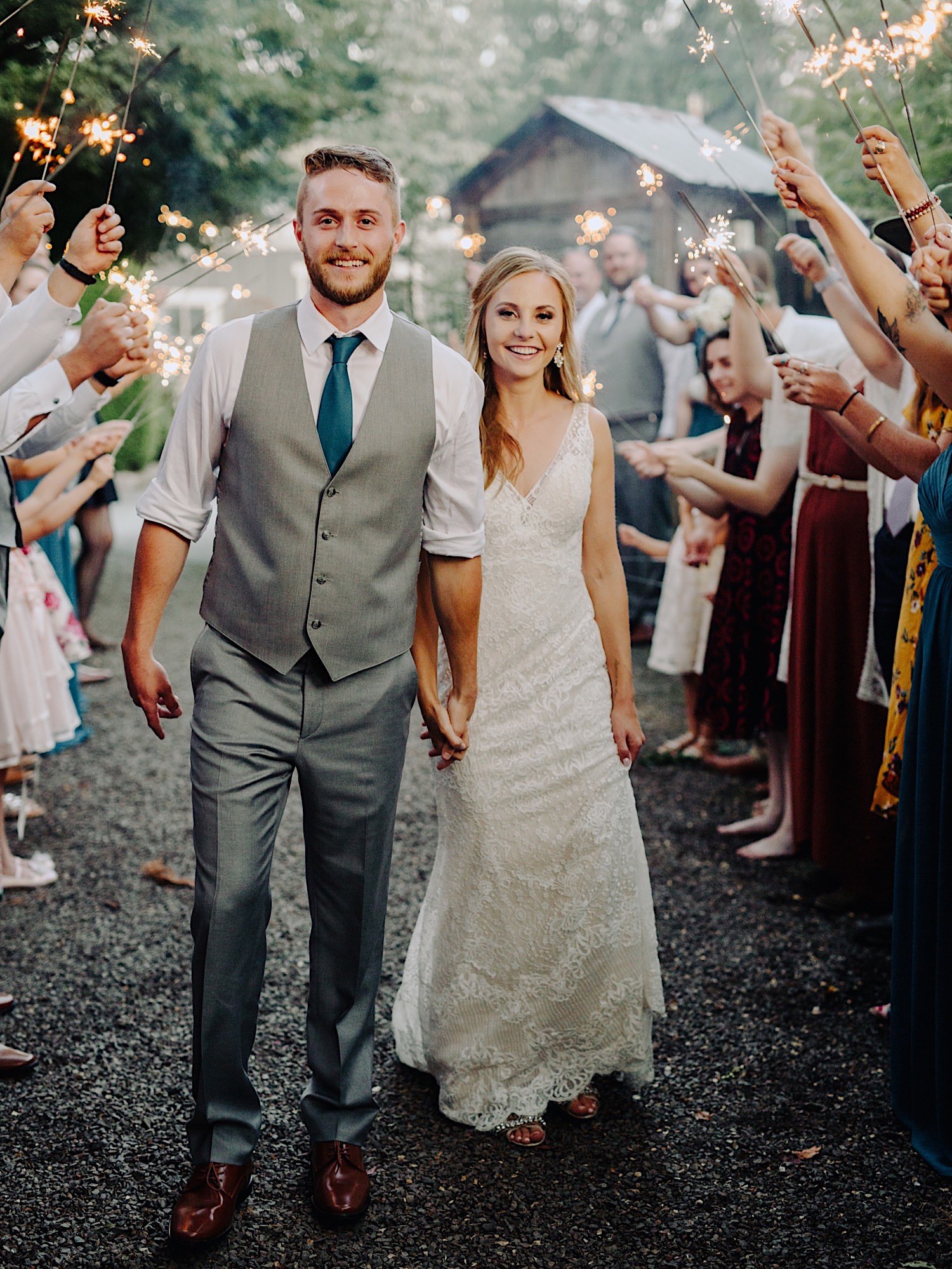wedding couple walking through sparklers at Pine Creek Farms and Nursery