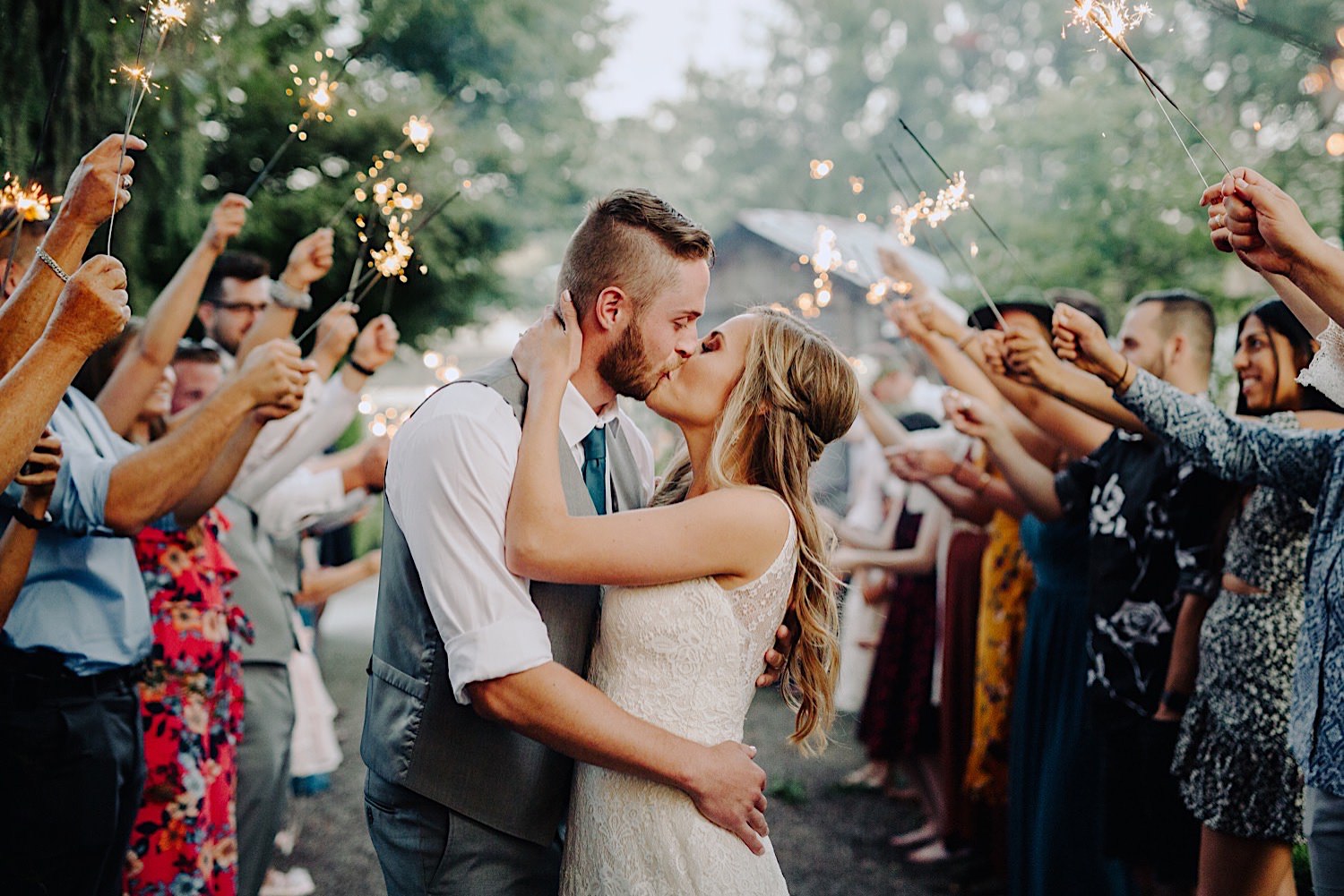 wedding couple kissing at sparkler exit at Pine Creek Farms and Nursery