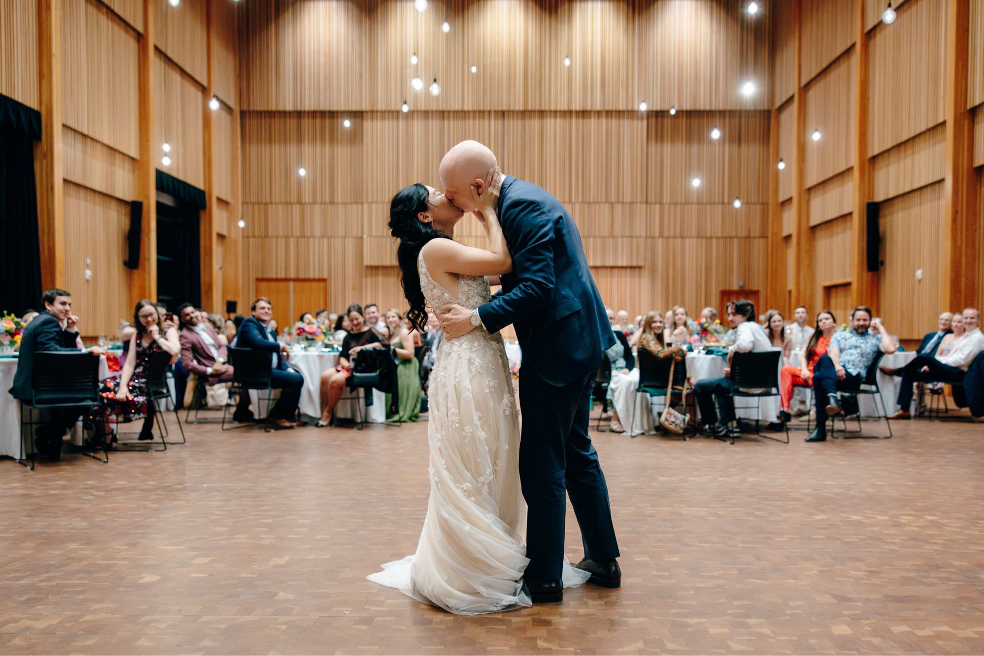 The couple kisses during their first dance in Osberg Hall at their National Nordic Museum wedding
