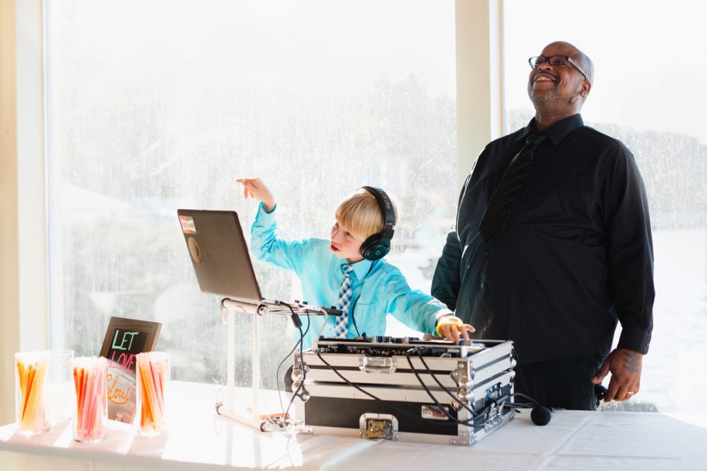 seattle wedding dj with wedding guest captured by photographer