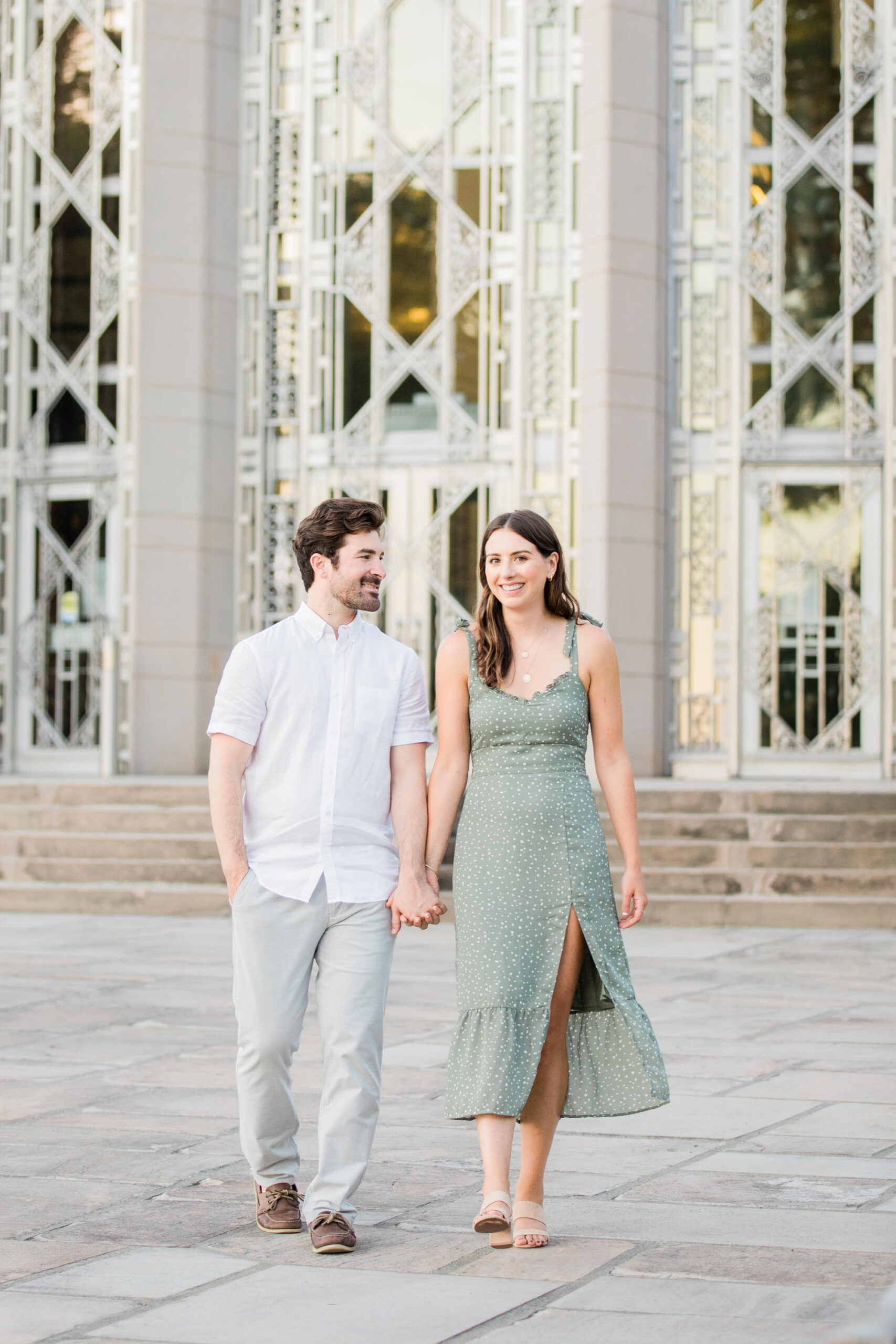 Couple walks together in front of the museum at Volunteer Park.