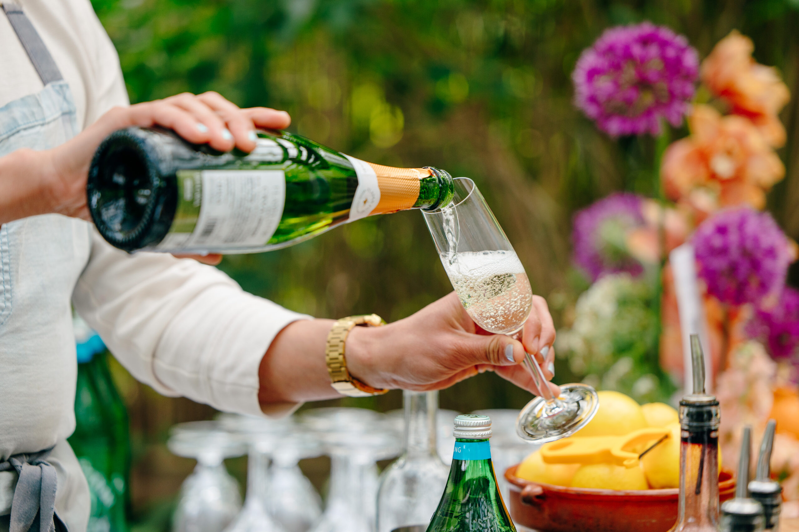 A server pours champagne at the Corson Building