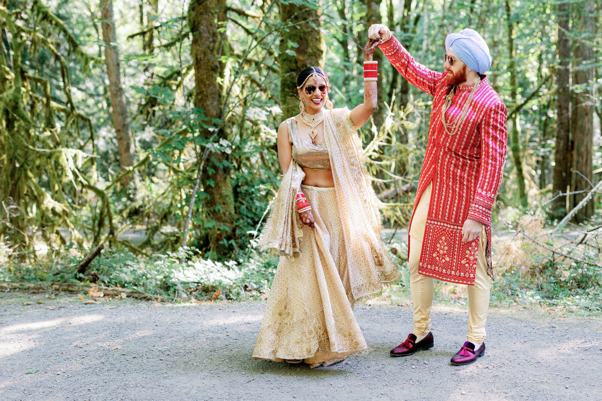 Groom twirling bride in the woods