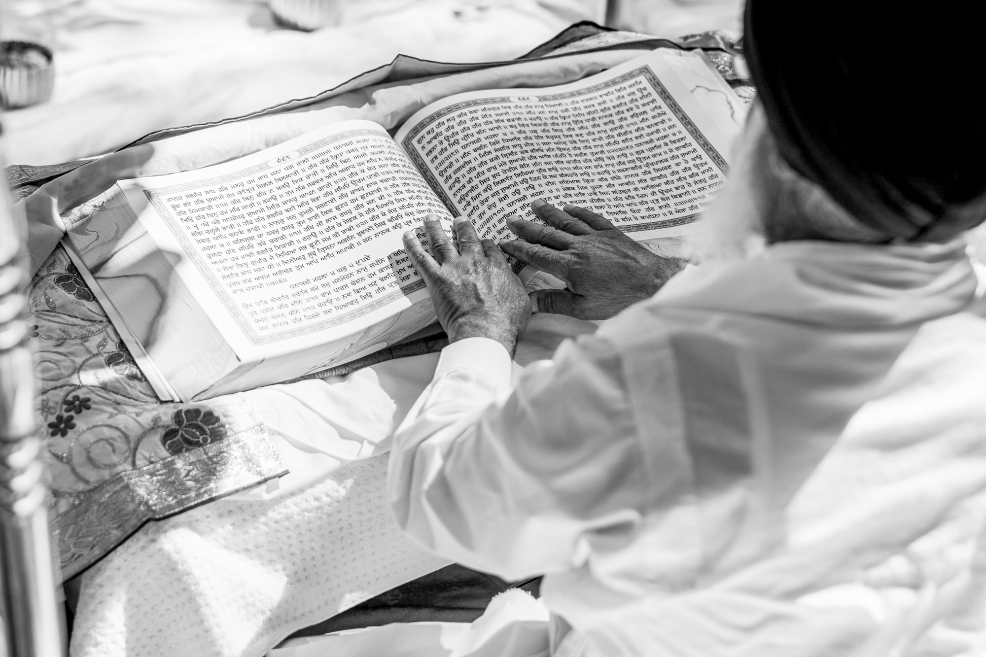 A priest reads the holy book during the wedding ceremony, emphasizing the importance of tradition.