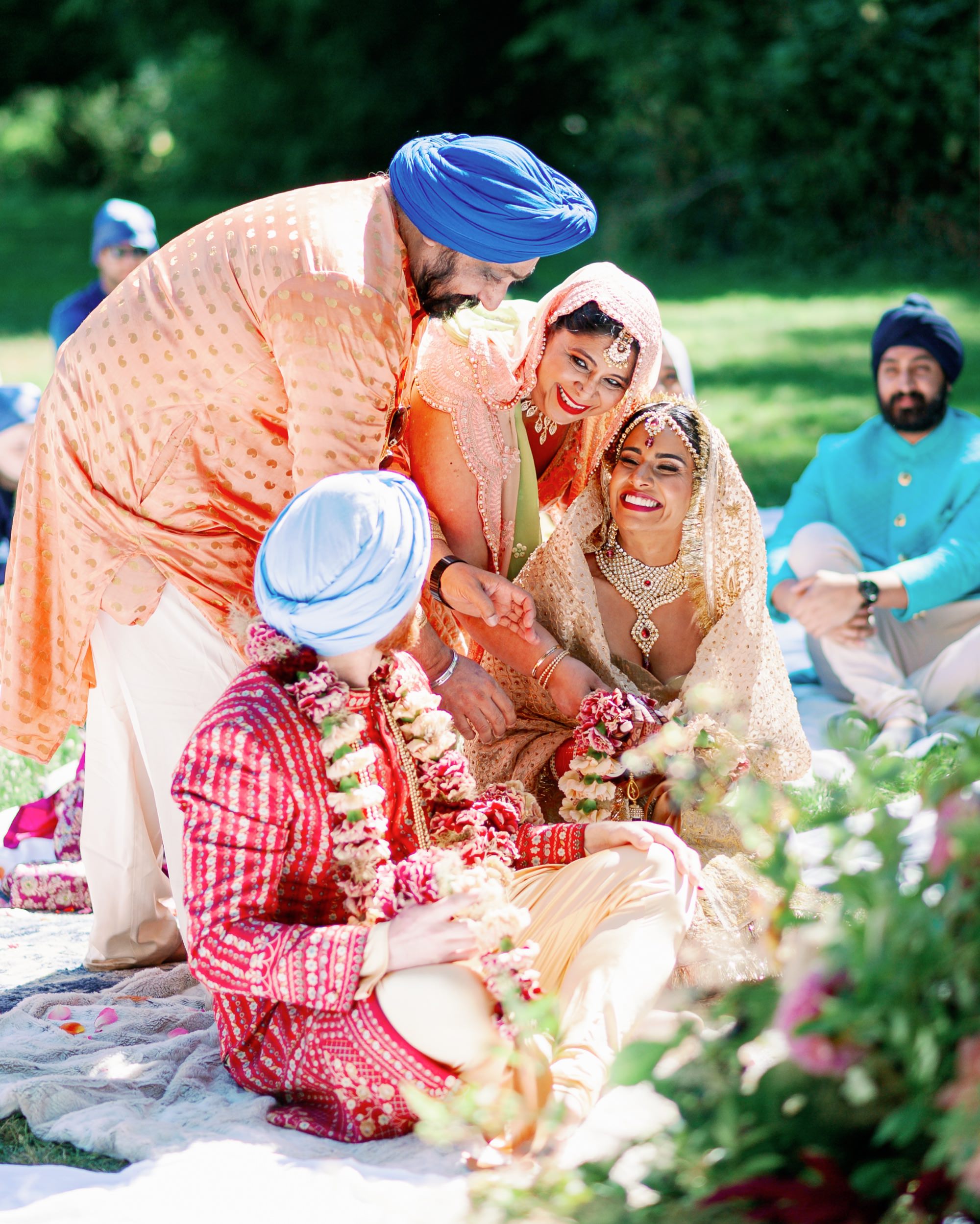 Family members surround the bride and groom, offering blessings and support during the ceremony.