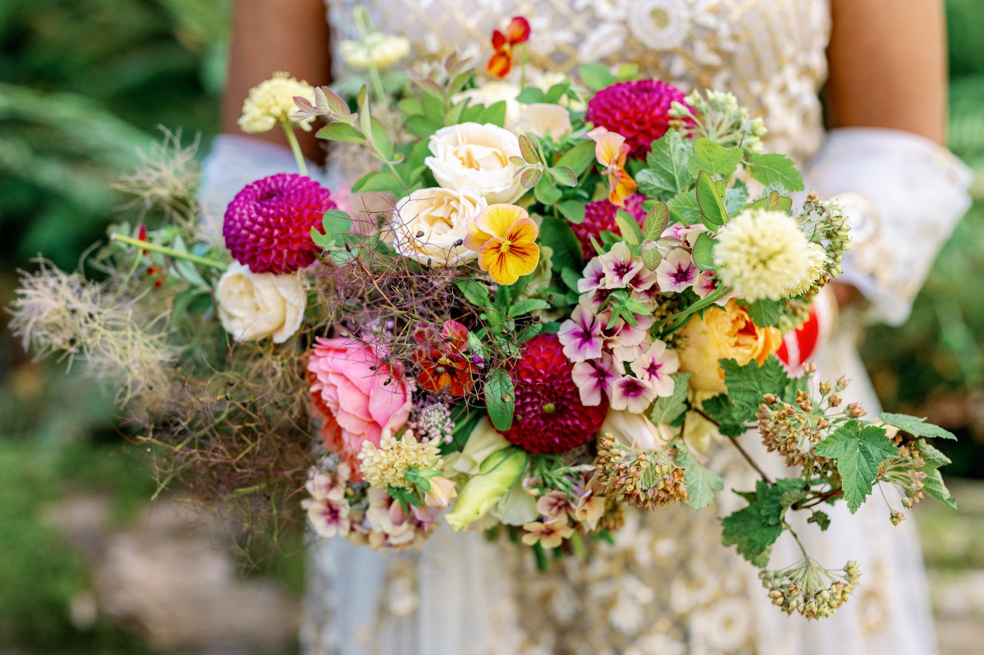 Bride holding a vibrant bouquet of mixed flowers