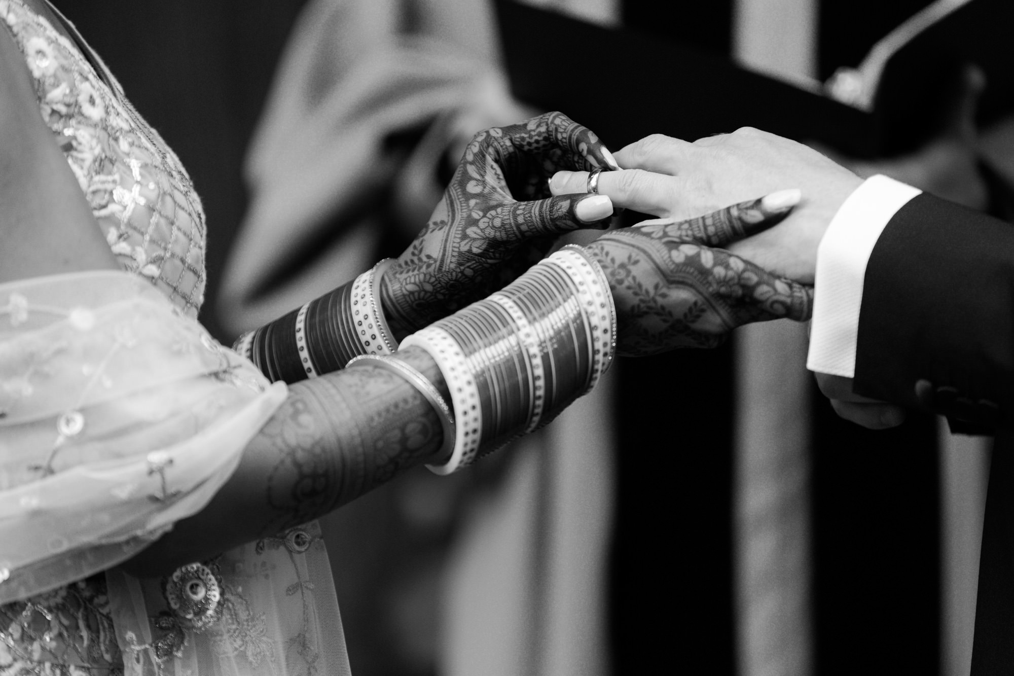 Close-up of bride and groom exchanging rings.