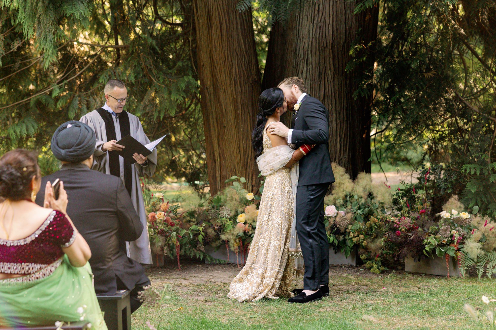 Bride and groom's first kiss as a married couple.