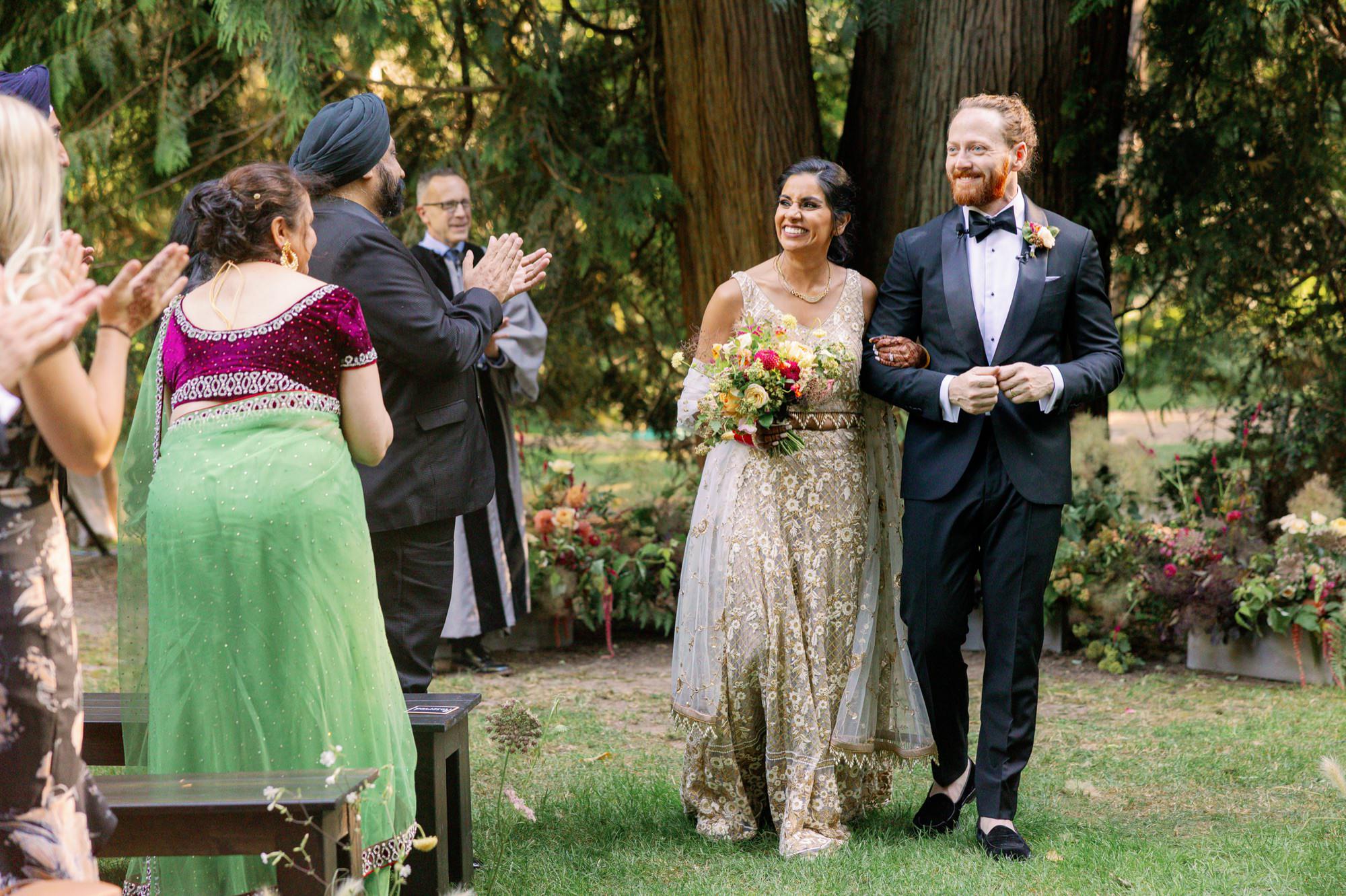 Bride and groom walking down the aisle after the ceremony.