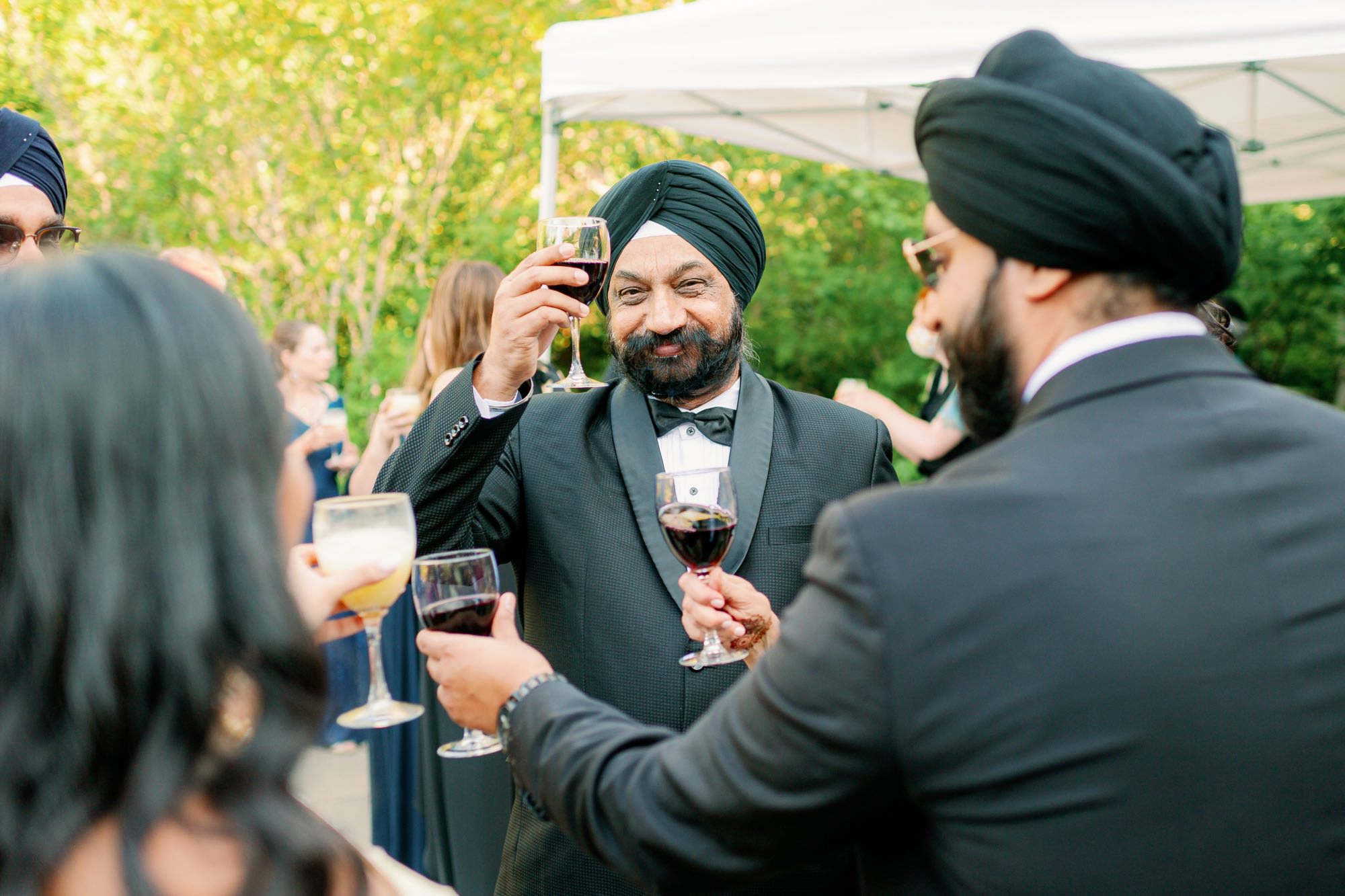 Guests raising glasses for a toast at the wedding reception.