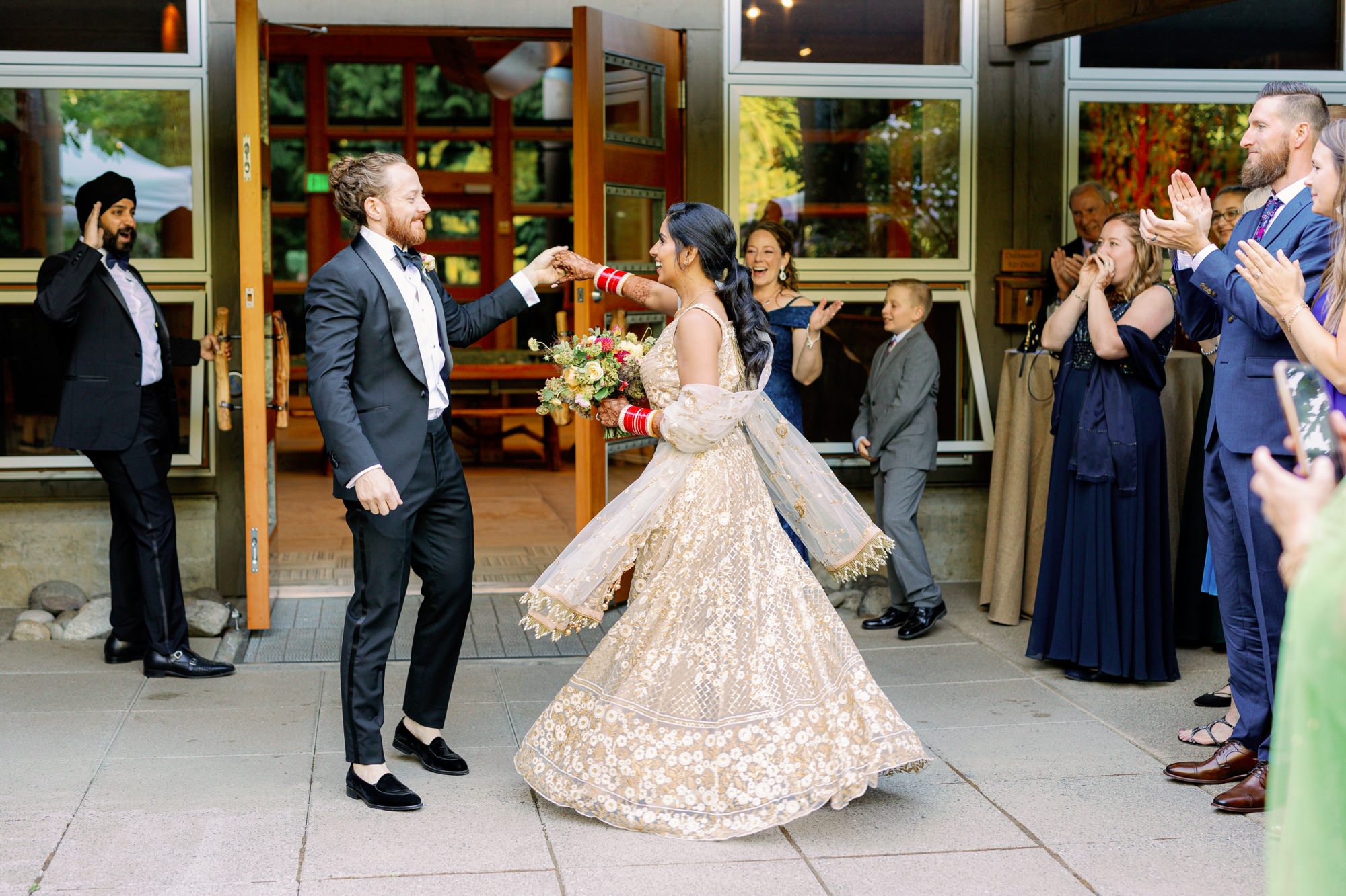 Bride and groom dancing with joy at their wedding reception.