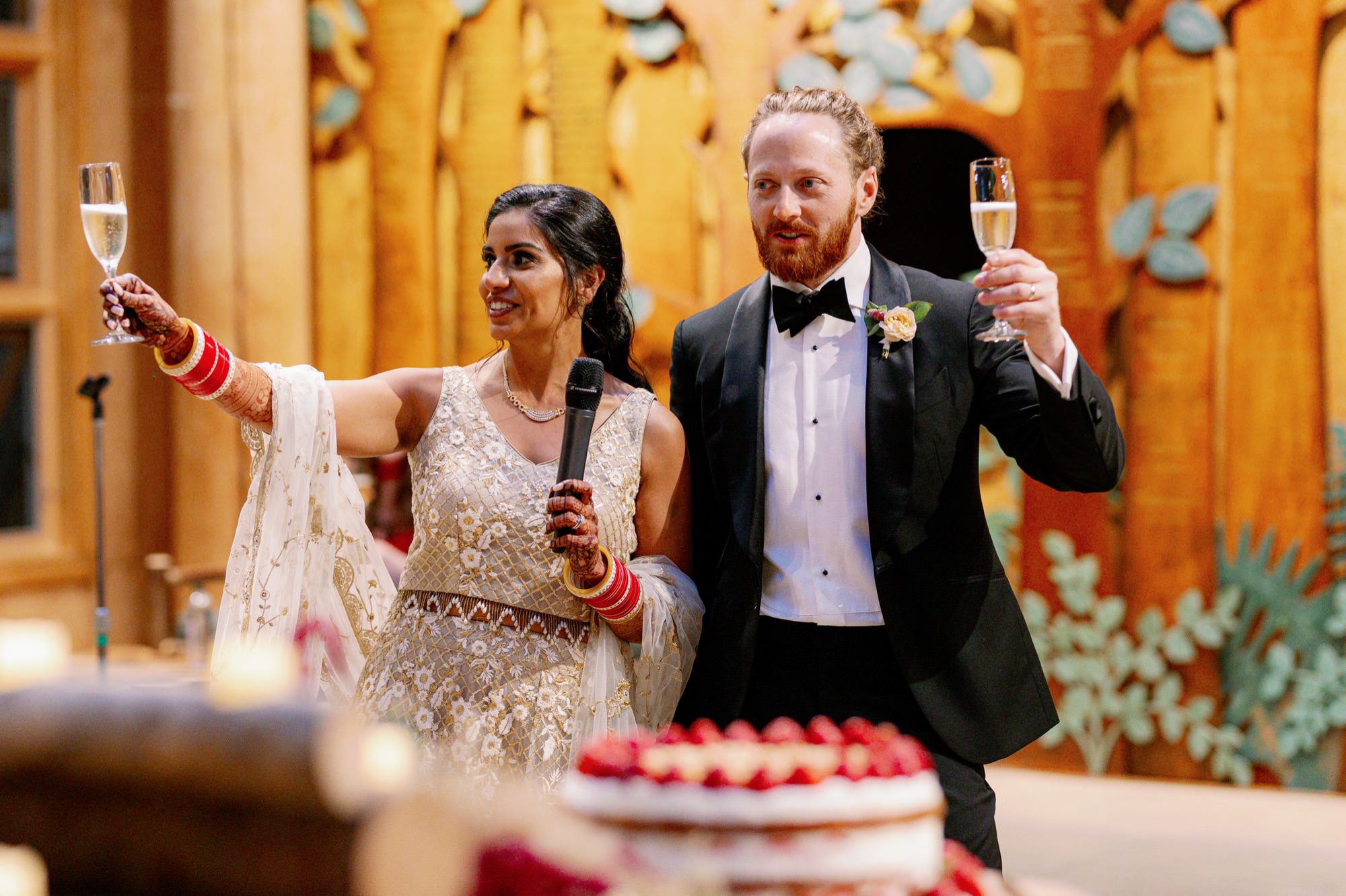 Bride and groom laughing while giving a speech at IslandWood wedding reception.