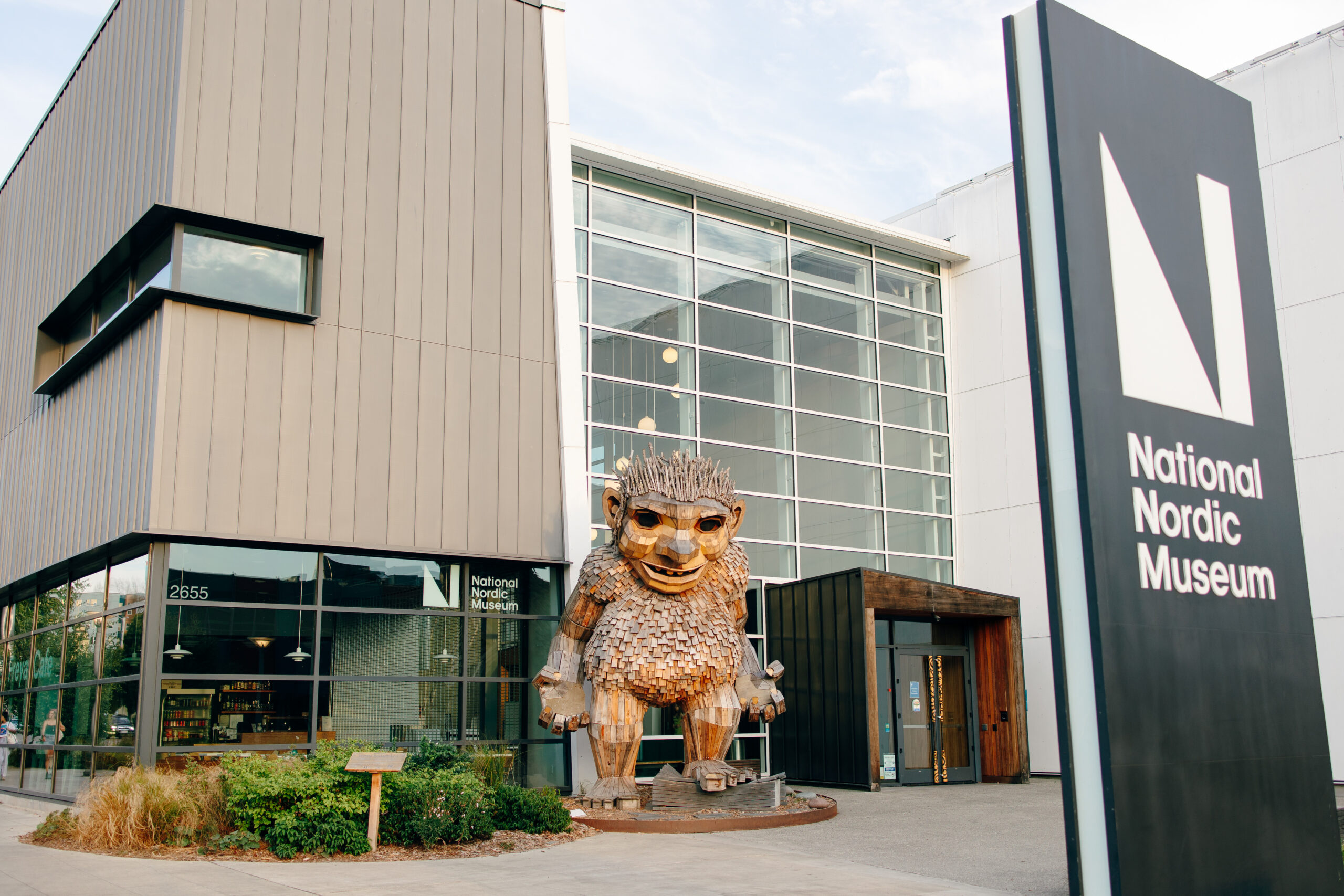 The wooden troll statue and sign for National Nordic Museum in Ballard.