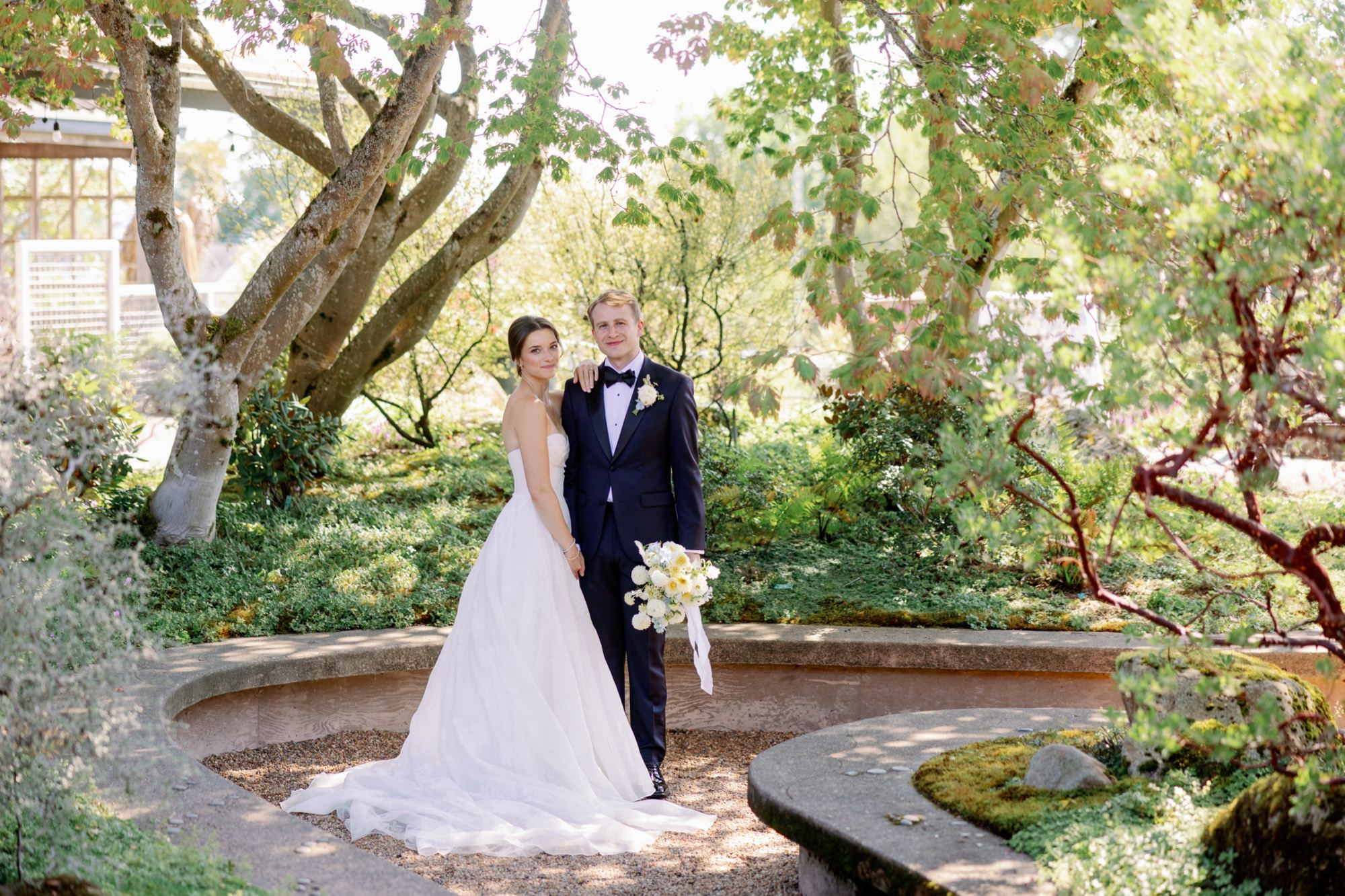 A wedding couple poses for portraits in the courtyard at their Center for Urban Horticulture Wedding.