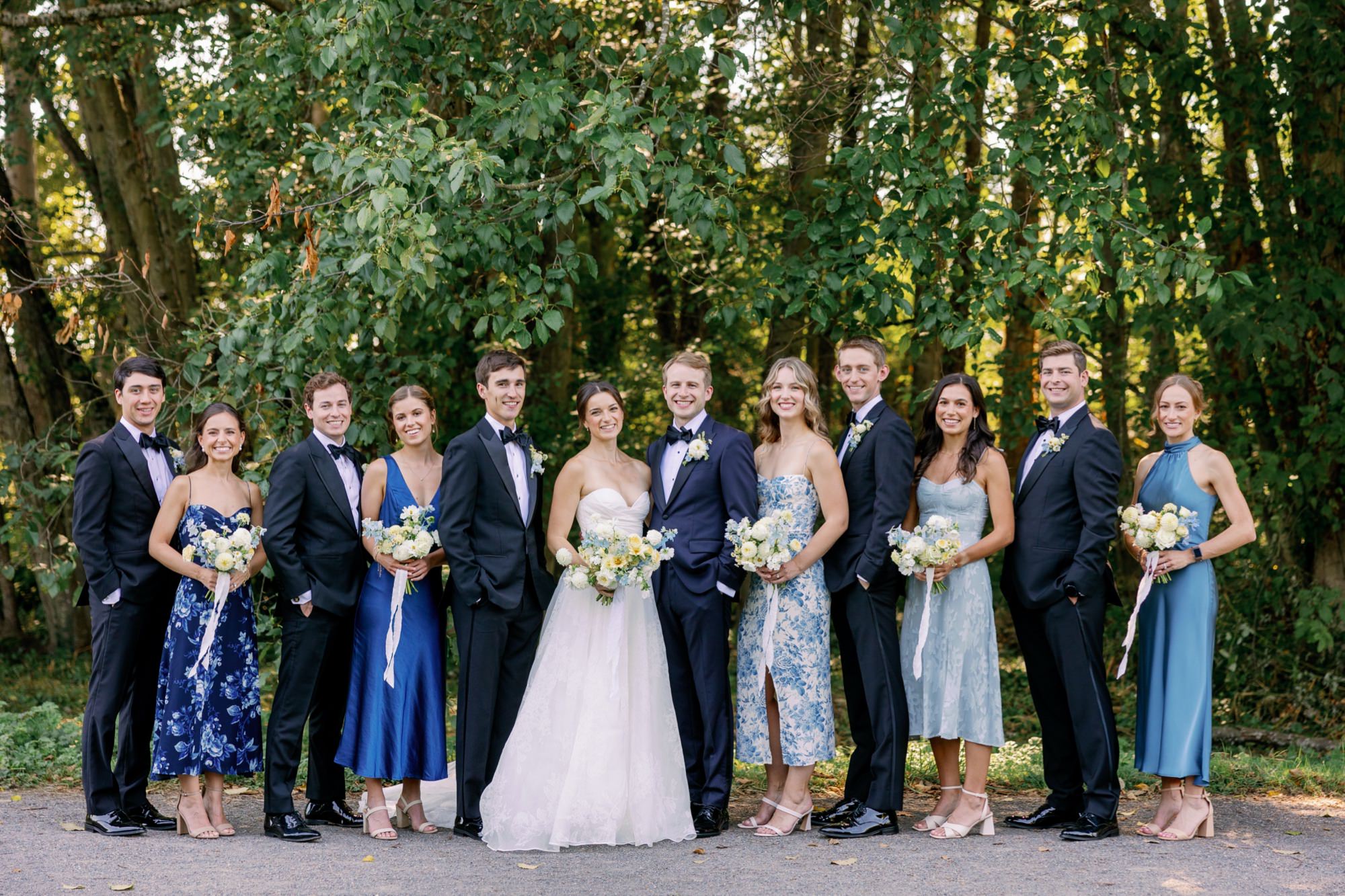 Wedding party standing together outdoors at the Center for Urban Horticulture, smiling and dressed for the ceremony.