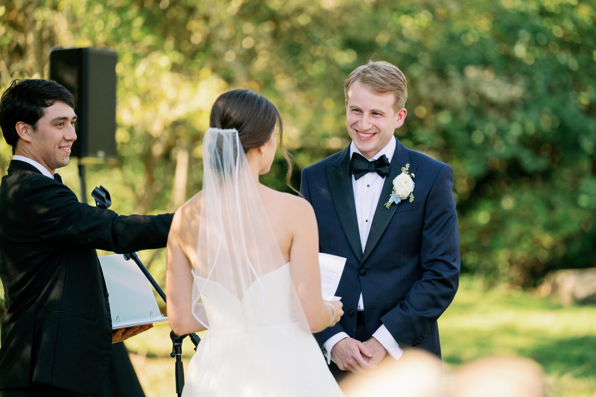 Couple exchanging vows during their outdoor ceremony.