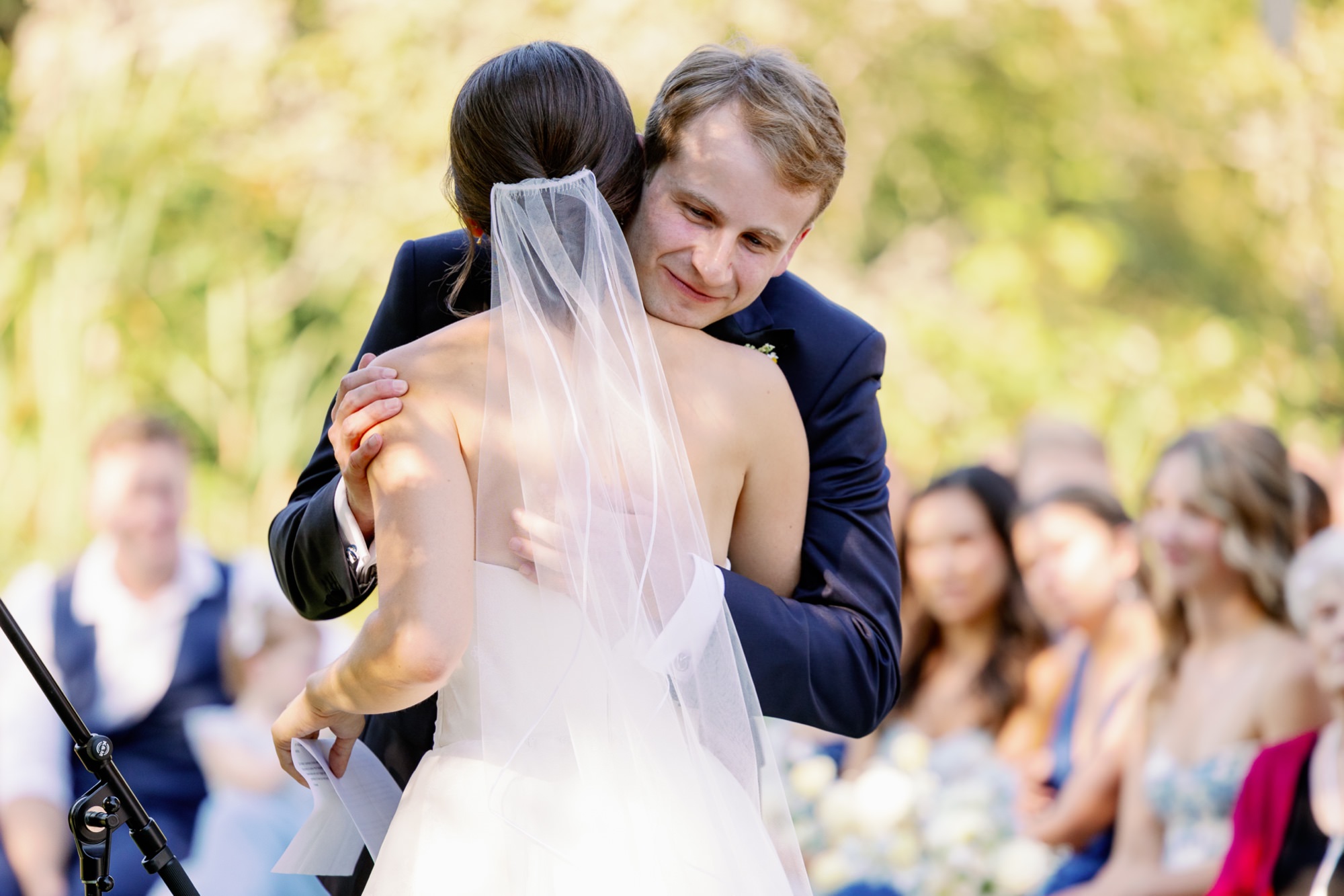 The groom hugs the bride during the wedding ceremony.