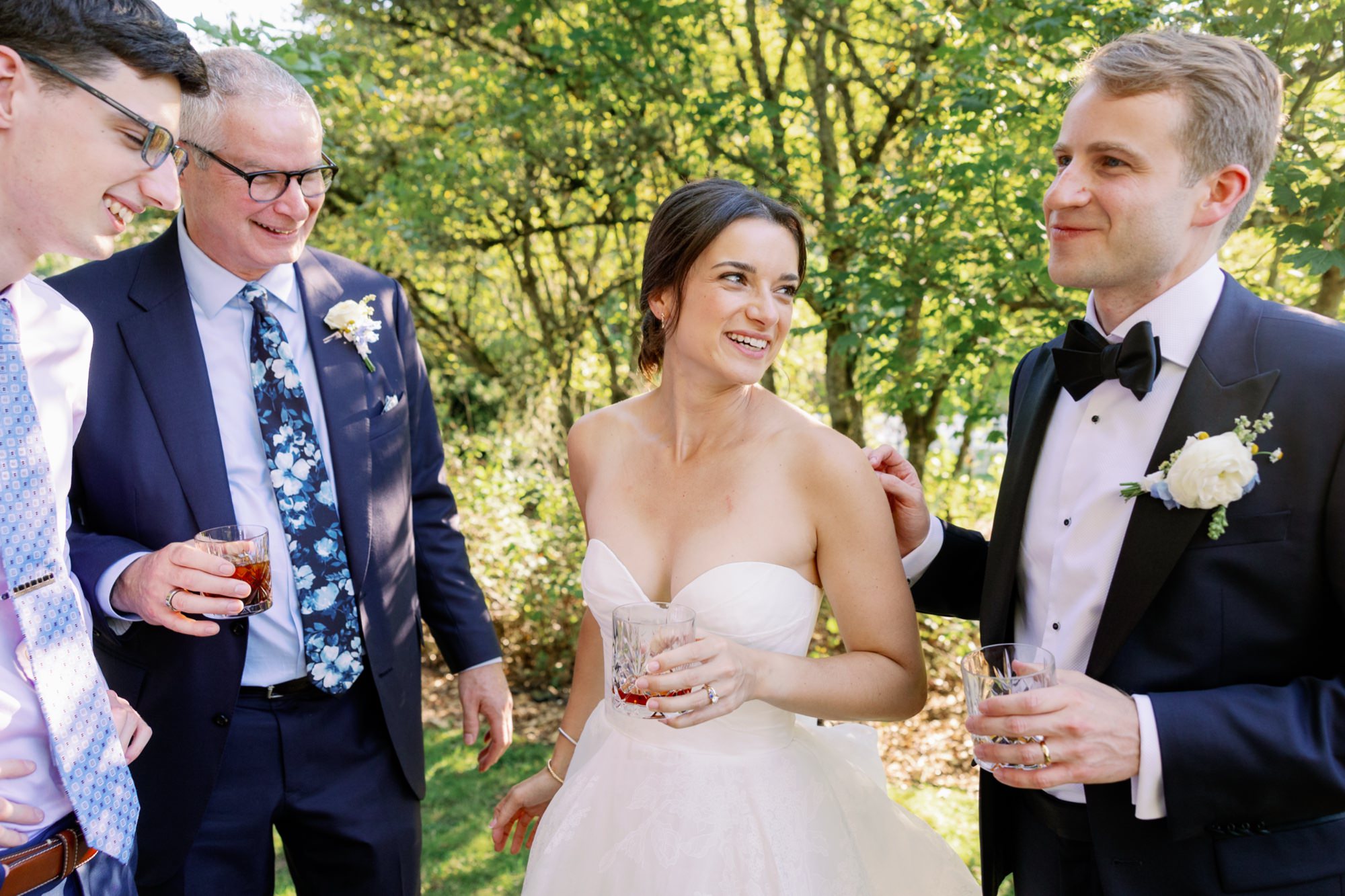 The couple mingles with wedding guests outside at the cocktail hour.