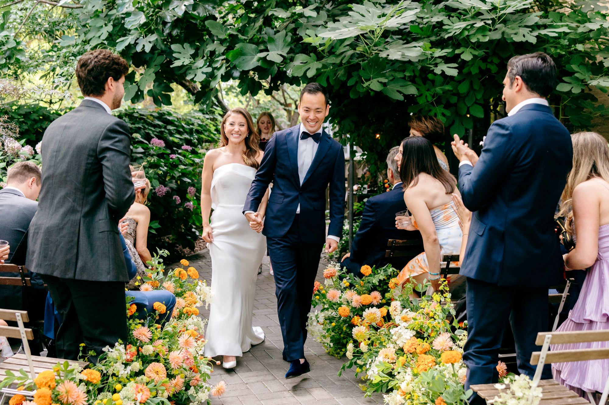 Bride and groom smile as they recess out of their wedding ceremony