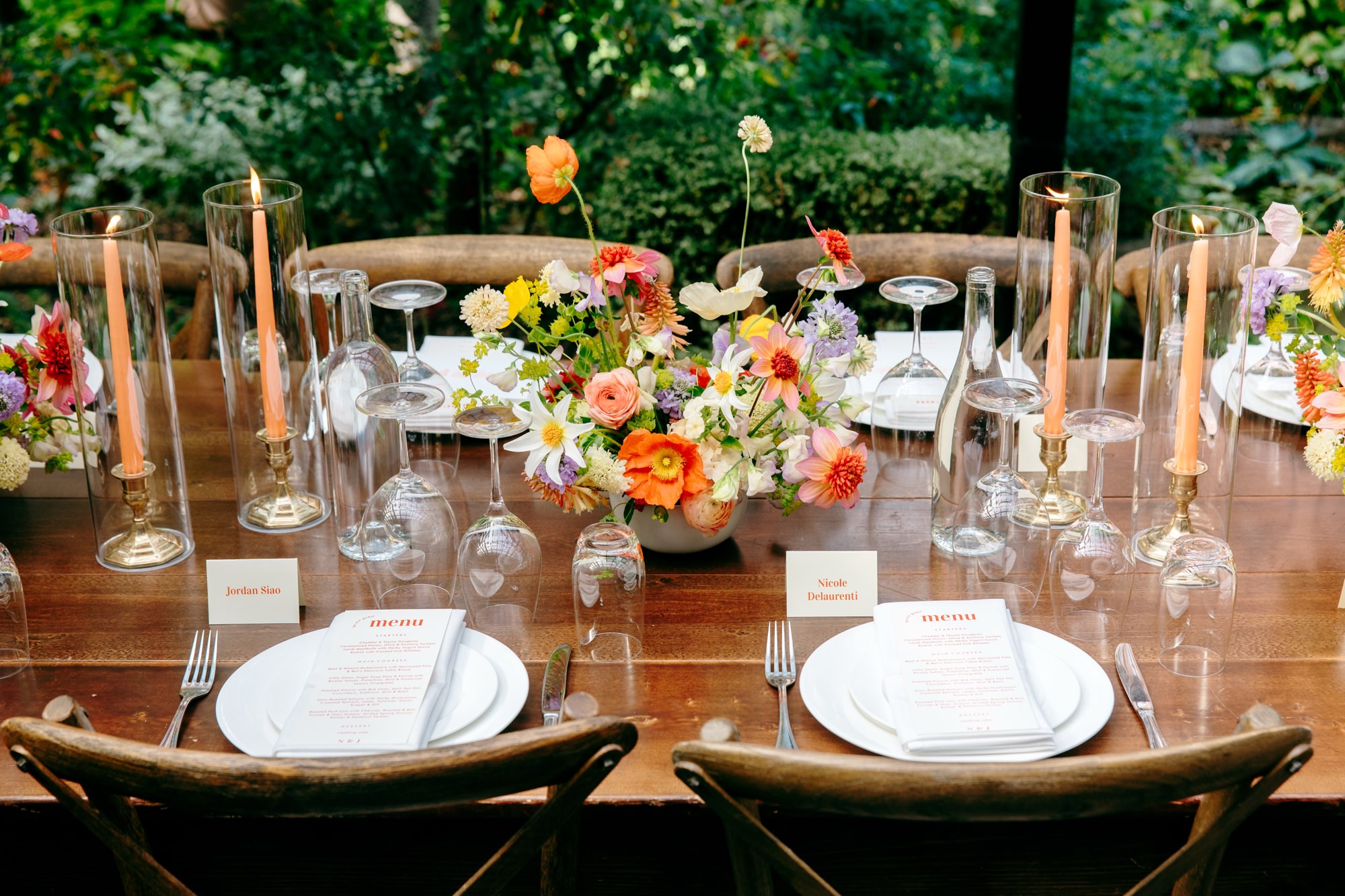Candles and vibrant floral centerpieces at a Corson Building family-style wedding dinner