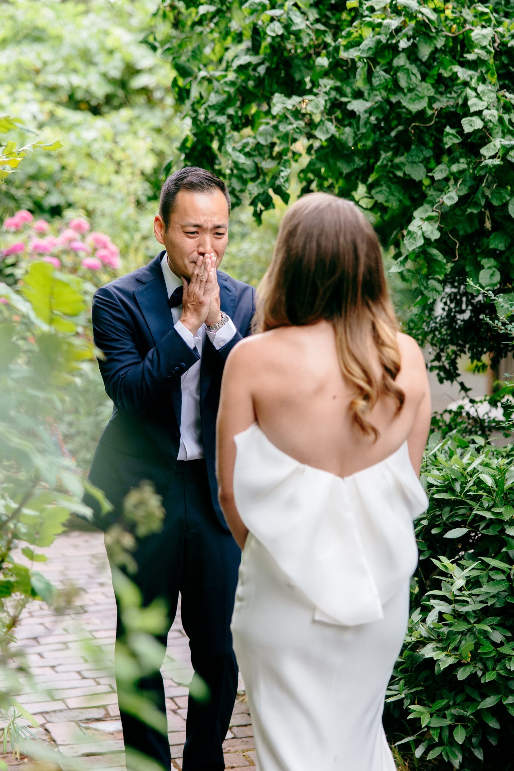 The groom puts his hands over his mouth during an emotional first look