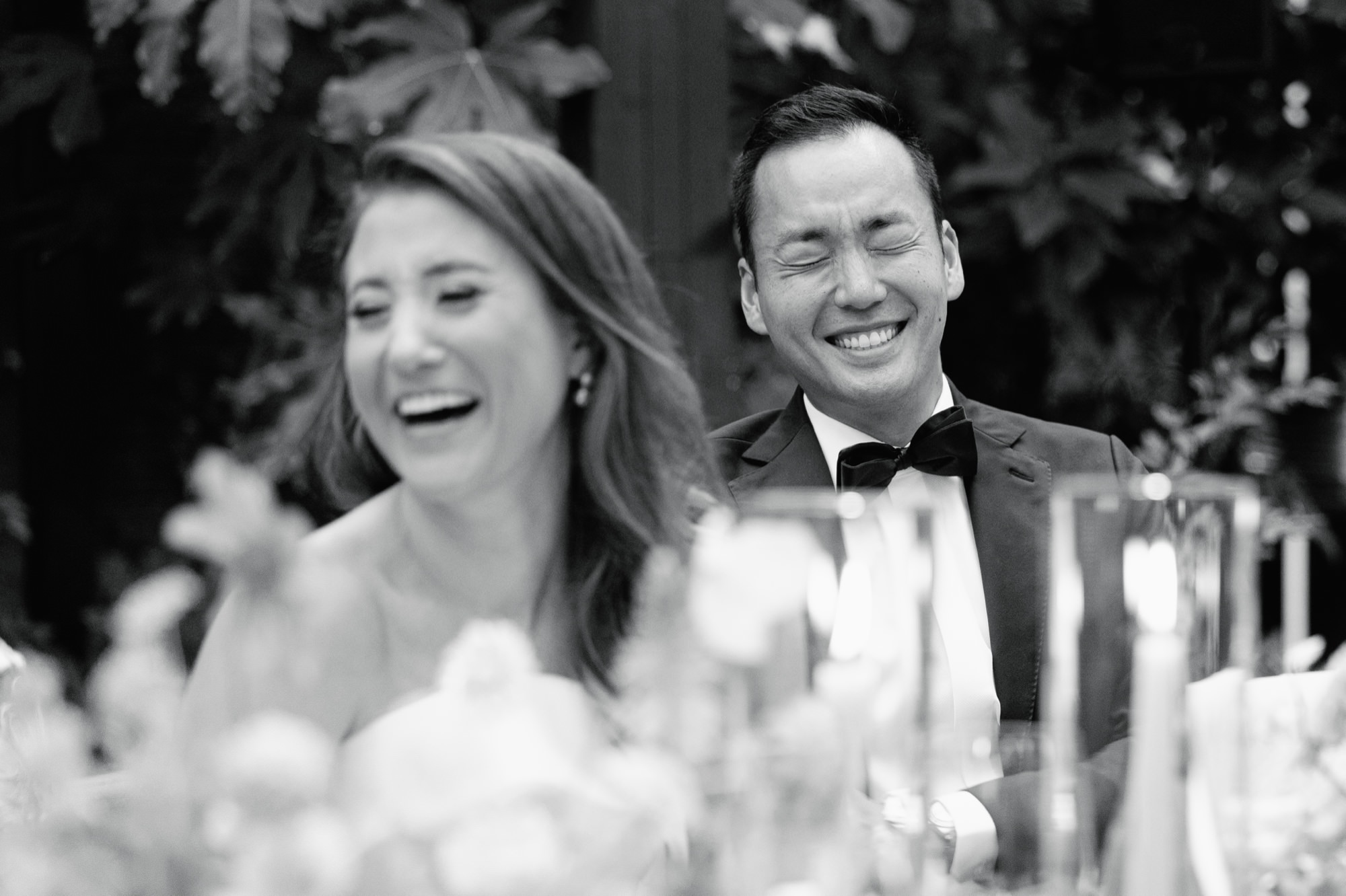 The groom laughs during speeches.