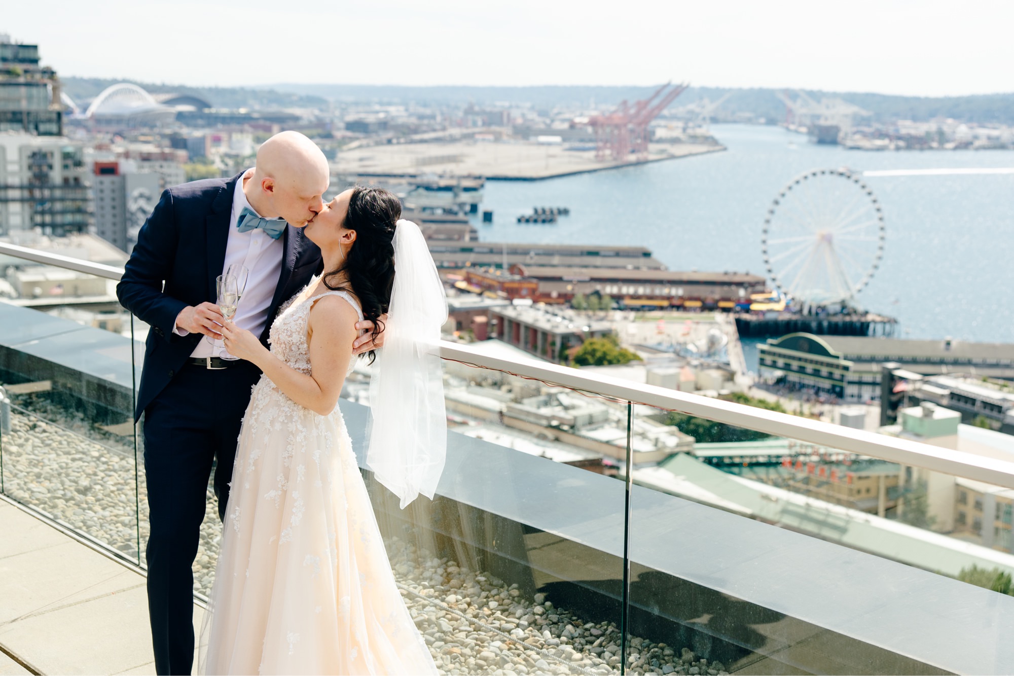 Couple kisses after their first look at The Nest in downtown Seattle. The Great Wheel is in the background.