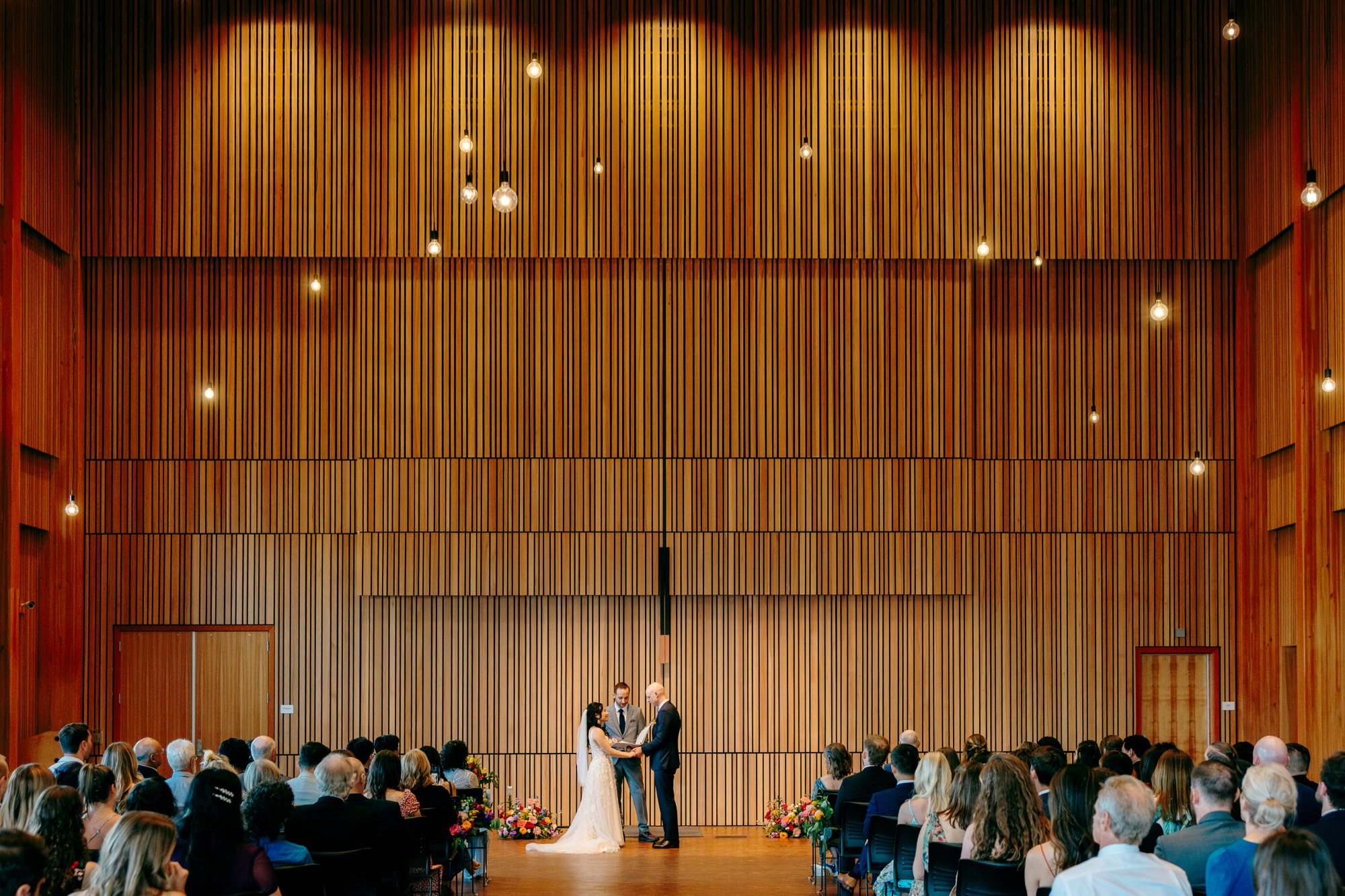 A wide angle view of Osberg Hall during the ceremony at a National Nordic Museum wedding.